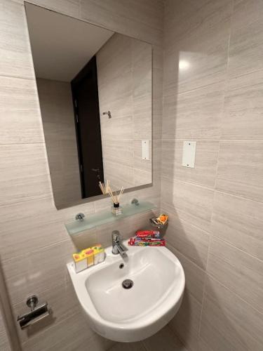 a bathroom with a sink and a mirror at VIP Luxury Premium Apartment in Manama