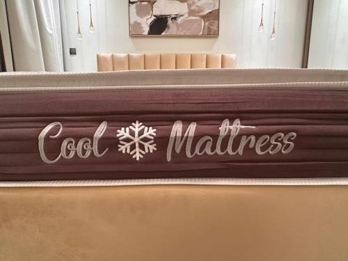 a bed with a coca cola sign on it at VIP Luxury Premium Apartment in Manama