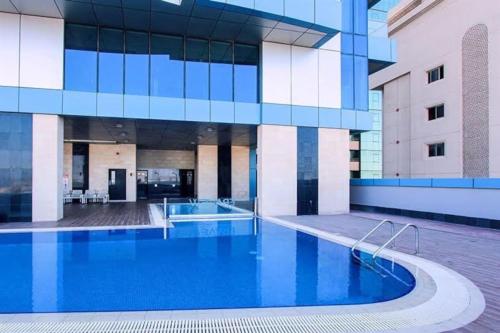 a large building with a pool in front of it at VIP Luxury Premium Apartment in Manama