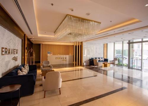 a lobby with a couch and chairs in a building at VIP Luxury Premium Apartment in Manama