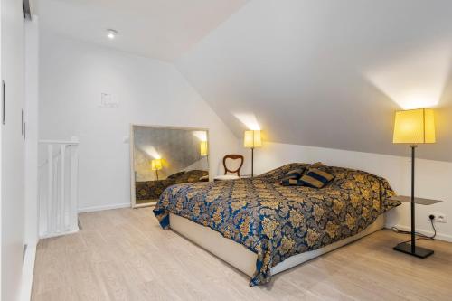 a bedroom with a bed and a lamp in it at Residentie Nevejan in Kortrijk