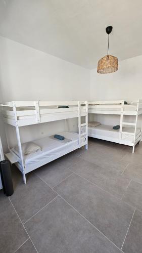two white shelves in a room with a tile floor at The Wave Temple II in Las Palmas de Gran Canaria