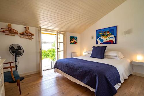 une chambre avec un lit avec une couverture bleue dans l'établissement Magnifique Maison de la Rivière, à Saint-Seurin-de-Prats