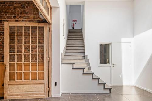 a staircase in a room with a brick wall at Residentie Nevejan in Kortrijk