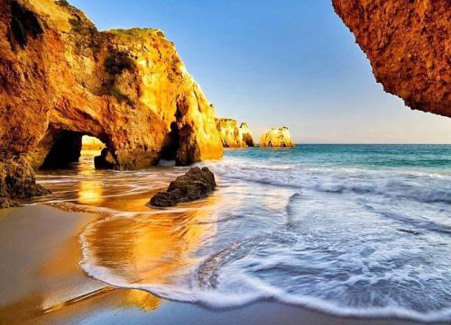 a view of a beach with rocks in the water at Stylish Apartment by Rocha Beach, Sleeps 5 in Portimão