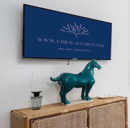 a green horse statue sitting on top of a dresser at Stylish Apartment by Rocha Beach, Sleeps 5 in Portimão