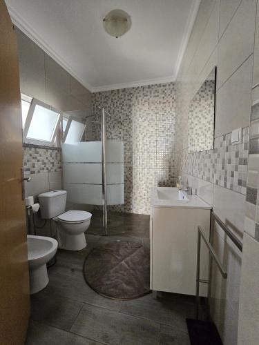 a bathroom with a toilet and a sink at Casa o Cantinho in Mourão