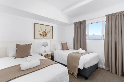 a hotel room with two beds and a window at Odeon Towers 1102 in Strand