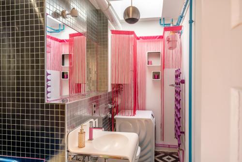 a pink bathroom with a sink and a toilet at Top floor Penthouse with Garden in Berlin