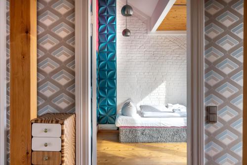 a bedroom with a bed and a brick wall at Top floor Penthouse with Garden in Berlin