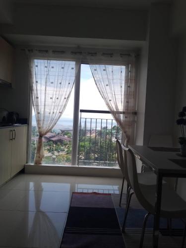 a room with a large window with a table and chairs at LM Trav accommodation and reservation services in Tagaytay