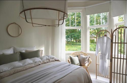a bedroom with a bed and a large window at Villa Solgården in Hanko