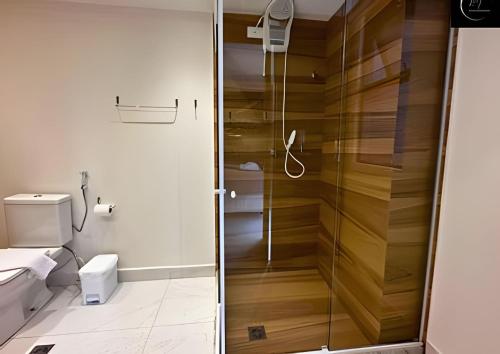 a bathroom with a shower and a toilet at LM Unity Cabo branco in Penha