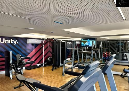 a gym with treadmills and machines in a room at LM Unity Cabo branco in Penha