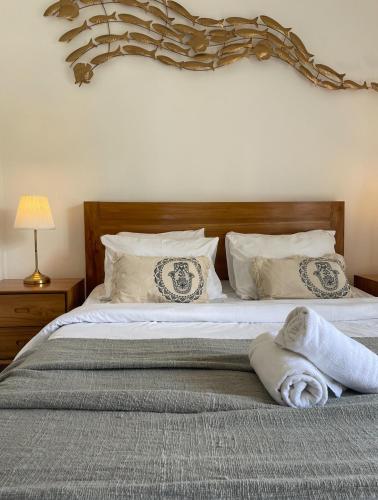 a bed with a towel laying on top of it at Central house 2 floor in Ubud