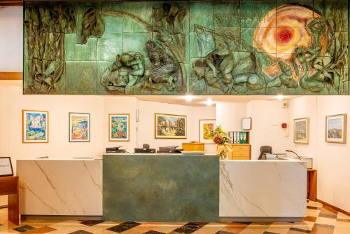 a lobby with a large painting on the wall at Hotel Palme & Suite in Garda