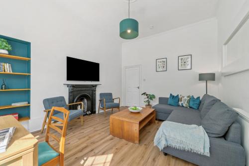 a living room with a couch and a table at Woodford Street in Mansewood