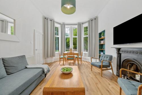 a living room with a couch and a table at Woodford Street in Mansewood