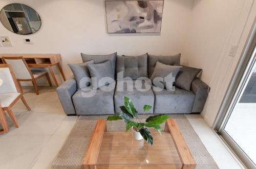a living room with a couch and a table at Fully Equipped Apt Close To Paseo La Galeria in Asuncion