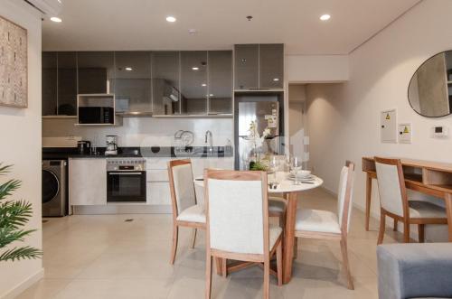 a kitchen and dining room with a table and chairs at Fully Equipped Apt Close To Paseo La Galeria in Asuncion