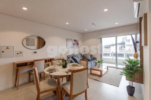 a dining room and living room with a table and chairs at Fully Equipped Apt Close To Paseo La Galeria in Asuncion