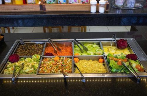 a buffet filled with many different types of food at Hotel 2 Irmãos in Campo Grande