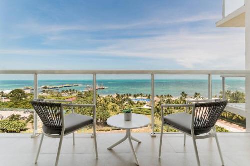 a balcony with a view of the ocean at MARINA Beachfront 2 BDR by CASA PARAISO in Cancún