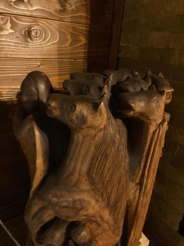 a wooden table with a carving of animals on it at Brvnara Leska in Jarmenovci