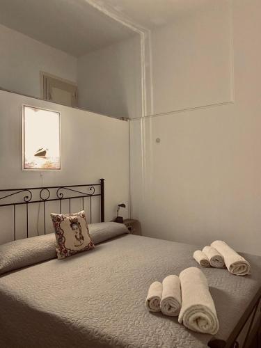 a bedroom with two beds with towels on them at Pamela House in Noto