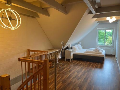 a attic bedroom with a bed and a window at Alt Mölln, Apartment 11 in Alt Mölln