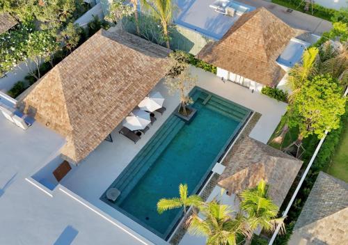 an overhead view of a swimming pool with a villa at New luxury villa with maid Anchan Tropicana in Bang Tao Beach