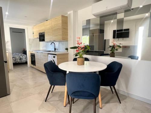 une cuisine avec une table et des chaises dans une cuisine dans l'établissement 9 écluses Canal du midi-Maison T3 belle vue avec Piscine, à Béziers