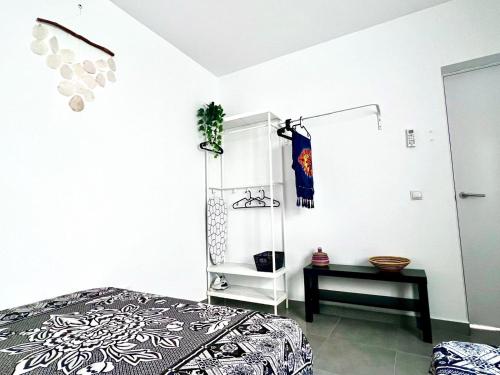 a white room with a bed and a shelf at Animoss! Apartments - 10 modern apartments near city center & beach in Santa Maria