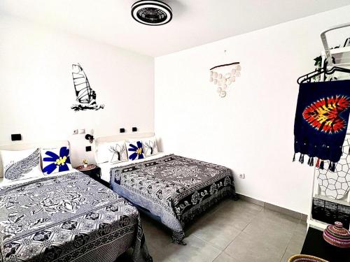 a bedroom with two beds in a room at Animoss! Apartments - 10 modern apartments near city center & beach in Santa Maria