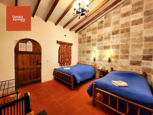 Una cama o camas en una habitación de Tambo Aymara