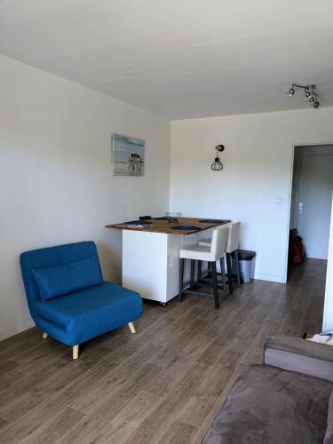 un salon avec une chaise bleue et un bureau dans l'établissement Adorable studio 3p HYERES Port plages, à Hyères