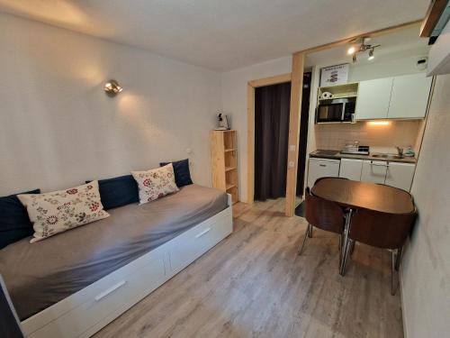 Cette petite chambre comprend un lit et une table. dans l'établissement Studio cosy 4 pers avec balcon exposé Est, au pied des pistes - FR-1-265-238, à Valfréjus