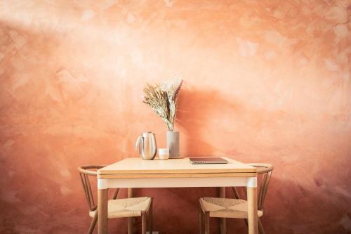 a table with two chairs and a vase of flowers on it at Spacious Green Apartment With Amazing Loft in Copenhagen