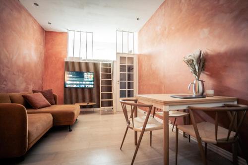 a living room with a table and a couch at Spacious Green Apartment With Amazing Loft in Copenhagen