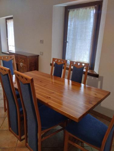 a dining room table with chairs and a wooden table and a table at Borgo Doccia 905 in Montese
