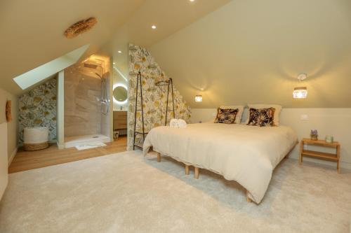 a bedroom with a large bed and a shower at Le Nature - Appartement 4p Wimille -Wimereux in Wimille