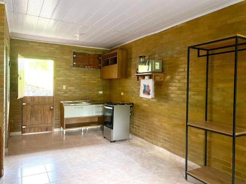 a kitchen with wooden walls and a stove top oven at Eco Flat 321 Condomínio Pedra do Rodeadouro in Bonito