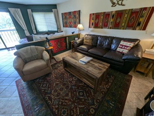 a living room with a couch and a coffee table at Bay View Luxury Studio in Bigfork