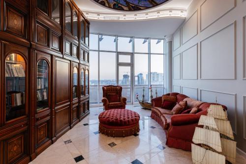 a living room with a couch and two chairs at Апартаменты RoofPort in Kyiv