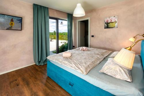a bedroom with a bed and a window at Villa Una Sofia in Pazin