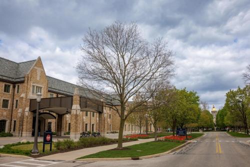 a building with a tree in front of a street at Morris Inn at Notre Dame in South Bend