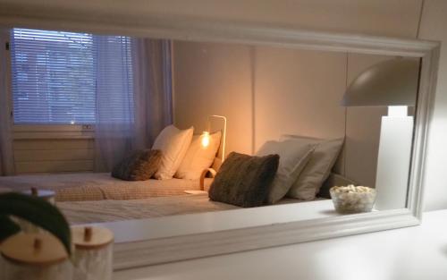 a mirror reflection of a bed in a bedroom at Aurora Guest Room in Rovaniemi