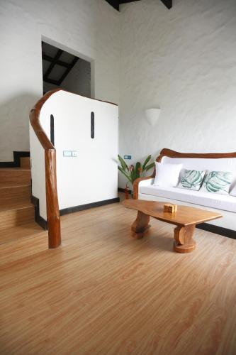 a living room with a bed and a coffee table at The Salty Palms in Beau Vallon