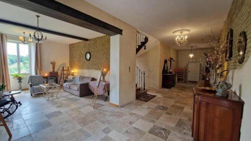 a large living room with a couch and a table at Aux roses de Cèdres in Salvagnac