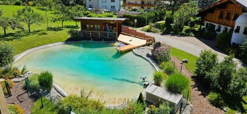 an overhead view of a large swimming pool with a house at Haus Montana in Elbigenalp